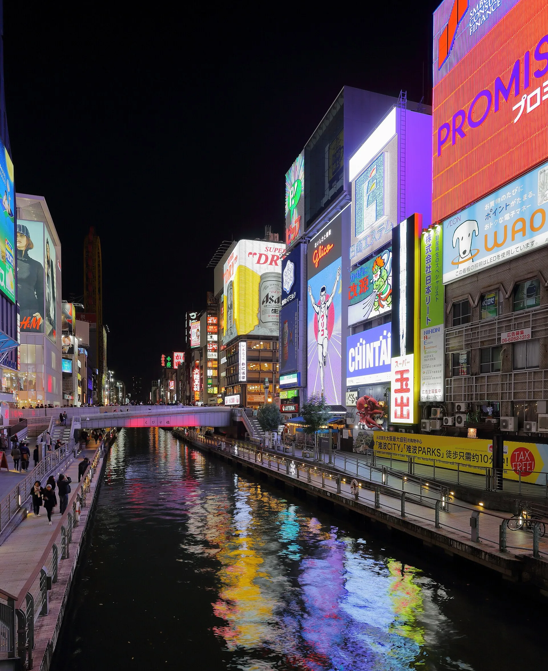Neon signs reflecting in the Dotonbori canal at night